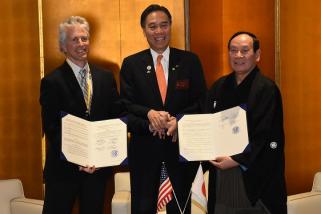 写真：協定書を手に握手する竹節町長、チェイピン町長、阿部知事